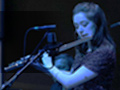 Flautist Jess Shand plays Breathing Together bathed in cool light